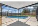 Inviting pool area with a screened enclosure, concrete deck, and a nice fence at 1436 Nolton Way, Orlando, FL 32822