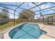 This inviting pool boasts a screened enclosure, concrete deck, and pristine blue water at 1436 Nolton Way, Orlando, FL 32822