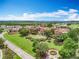 Gorgeous aerial shot of a Mediterranean-style estate with a meticulously maintained lawn and lush greenery at 15121 Pendio Dr, Montverde, FL 34756