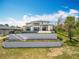 An elevated view of the backyard featuring a modern pool with black framed glass doors to the residence at 15121 Pendio Dr, Montverde, FL 34756