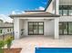 Outdoor patio with built-in grill, with views of a lake, that's perfect for cooking and entertaining at 15121 Pendio Dr, Montverde, FL 34756