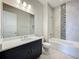 Bathroom featuring a gray tile backsplash, a modern vanity and bath tub at 15121 Pendio Dr, Montverde, FL 34756