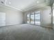 This spacious bedroom features a tray ceiling, recessed lighting, a large window and access to a private balcony at 15121 Pendio Dr, Montverde, FL 34756