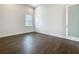 Empty bedroom with hardwood floors, a bright window and access to an attached bathroom at 15121 Pendio Dr, Montverde, FL 34756