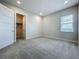 Bedroom with plush carpets, neutral walls, and an open closet with ample storage space at 15121 Pendio Dr, Montverde, FL 34756