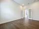 Empty bedroom with hardwood floors, recessed lighting and double glass doors to the stairwell at 15121 Pendio Dr, Montverde, FL 34756