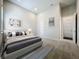 A modern bedroom features a neutral color palette, stylish furnishings, and artistic wall decor for a serene retreat at 15121 Pendio Dr, Montverde, FL 34756