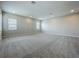 Expansive bonus room with neutral walls, plush carpeting and natural light from the windows at 15121 Pendio Dr, Montverde, FL 34756