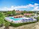 Community pool area featuring ample lounge seating and manicured greenery at 15121 Pendio Dr, Montverde, FL 34756