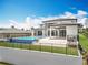 Exterior view of the house featuring an amazing in-ground swimming pool and lush backyard at 15121 Pendio Dr, Montverde, FL 34756