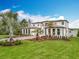 Expansive two-story home on the water with a wide driveway and lush lawn at 15121 Pendio Dr, Montverde, FL 34756