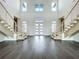 Bright and airy grand foyer with dual staircases, creating a stunning entrance to this beautifully designed home at 15121 Pendio Dr, Montverde, FL 34756