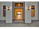 Grand front entrance with stone accents, modern lighting, and steps leading to a spacious interior at 15121 Pendio Dr, Montverde, FL 34756