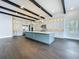 Modern kitchen with a center island, hardwood floors, sleek appliances, and custom cabinetry at 15121 Pendio Dr, Montverde, FL 34756
