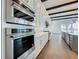 Professional grade stainless steel KitchenAid appliances with custom cabinets in a modern kitchen at 15121 Pendio Dr, Montverde, FL 34756