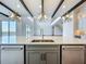Kitchen island featuring a sink, designer pendant lights, and stainless steel appliances at 15121 Pendio Dr, Montverde, FL 34756