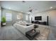 Spacious living area features a modern sofa, entertainment center, and large windows for natural light and comfortable living at 15121 Pendio Dr, Montverde, FL 34756