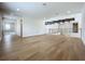 An open living area with hardwood floors, metal railings, and exposed beams provides a modern and spacious gathering space at 15121 Pendio Dr, Montverde, FL 34756