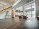 Bright open-concept living area featuring high ceilings, a modern staircase, and seamless access to the outdoor living space at 15121 Pendio Dr, Montverde, FL 34756