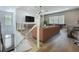 The lofted living area features hardwood floors, metal railings, and a view of the lower level and backyard at 15121 Pendio Dr, Montverde, FL 34756
