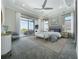 This beautiful main bedroom features a sitting area, tray ceiling, fan, and access to a private balcony at 15121 Pendio Dr, Montverde, FL 34756