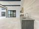 Outdoor kitchen with a stainless steel grill and sink, perfect for entertaining guests by the pool at 15121 Pendio Dr, Montverde, FL 34756