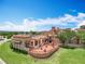 Picturesque outdoor patio with stone detailing, covered dining area, and manicured lawn at 15121 Pendio Dr, Montverde, FL 34756