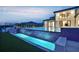 Luxury home featuring a modern pool with tiered waterfall features and meticulously landscaped backyard at 15121 Pendio Dr, Montverde, FL 34756