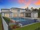 Backyard pool area with a built-in outdoor kitchen, featuring a modern design and ample space for relaxation and entertainment at 15121 Pendio Dr, Montverde, FL 34756