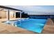 Modern pool with hot tub and stone patio, perfect for relaxing evenings with waterfront view at 15121 Pendio Dr, Montverde, FL 34756
