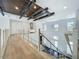 A modern staircase features wood steps, metal railings, and a striking ceiling design with wood beams and recessed lighting at 15121 Pendio Dr, Montverde, FL 34756