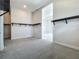 Spacious walk-in closet with multiple hanging rods and built-in shelving and plush carpeted floors at 15121 Pendio Dr, Montverde, FL 34756