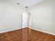 This is a spacious bedroom featuring hard wood flooring and neutral-toned walls at 15341 Groose Point Ln, Clermont, FL 34714