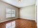 This is a naturally lit bedroom with tile flooring and a large window at 15341 Groose Point Ln, Clermont, FL 34714