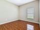 This bright bedroom has wood-look tile floors and a window providing natural light at 15341 Groose Point Ln, Clermont, FL 34714