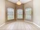 Bright dining area featuring tile flooring and large windows offering plenty of natural light, enhancing the home's appeal at 15341 Groose Point Ln, Clermont, FL 34714