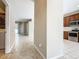 Open hallway leading to the kitchen with stainless steel appliances and a view of the backyard, creating a seamless flow at 15341 Groose Point Ln, Clermont, FL 34714
