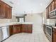 Kitchen with stainless steel appliances, wood cabinets and view to the dining and living areas at 15341 Groose Point Ln, Clermont, FL 34714