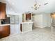 Open concept dining and kitchen area with view to the kitchen featuring wood cabinets at 15341 Groose Point Ln, Clermont, FL 34714
