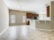 Open concept kitchen and dining area with tile flooring and traditional chandelier at 15341 Groose Point Ln, Clermont, FL 34714