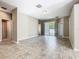 Spacious living room featuring tile floors and sliding glass doors leading to the outdoor space, seamlessly connecting indoors and outdoors at 15341 Groose Point Ln, Clermont, FL 34714