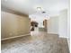 Spacious living room featuring tile floors and open access to the kitchen, creating a seamless and inviting living space at 15341 Groose Point Ln, Clermont, FL 34714