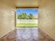 Covered patio with tiled floors offers a view of the fenced backyard at 15341 Groose Point Ln, Clermont, FL 34714