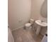 Bathroom features toilet, sink, and tile floor at 1556 Aspen Ave, Davenport, FL 33837