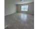 Well-lit room featuring neutral walls and tile flooring with a window bringing in natural light at 1556 Aspen Ave, Davenport, FL 33837