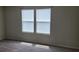 Bedroom with two windows providing natural light and neutral carpeting throughout the room at 1556 Aspen Ave, Davenport, FL 33837