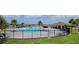 Beautiful community pool with lush landscaping and covered seating areas for residents at 1556 Aspen Ave, Davenport, FL 33837