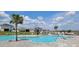 Resort style community pool with a splash pad for , surrounded by comfortable lounge chairs at 1556 Aspen Ave, Davenport, FL 33837