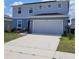 Charming two-story home with a spacious two car garage and a concrete driveway at 1556 Aspen Ave, Davenport, FL 33837