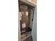Close-up of a HVAC unit with visible branding and regulatory documents within a utility closet at 1556 Aspen Ave, Davenport, FL 33837